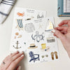 Emily Lex Studio Seaside Sticker Sheet - model shown removing sticker from sticker sheet