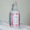 R+Co Candy Stripe Protect + Prep Detangling Spray - product shown on towels