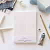 Emily Lex Studio Seaside Paintable Notecards - product shown next to paint tube, paint brush, ribbon, cloth, and starfish