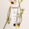 Essential Parfums Hand Cream - Rose Magnetic - product with flowers in the background