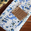 Leah Duncan Garden Friends Art Tea Towel - product shown folded and wrapped with twine and info tag
