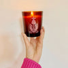 The Quiet Botanist Orchard Sun Scented Candle - model shown holding lit candle