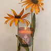 The Quiet Botanist Orchard Sun Scented Candle - product shown with flowers