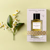 Lifestyle shot top view of Essential Parfums Neroli Botanica By Anne Flipo (100 ml) in box with Neroli flowers next to the box