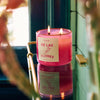 ROEN Candles De Las Flores Scented Candle - product shown lit and on shelf