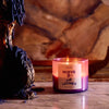ROEN Candles Nueve Leones Scented Candle - product shown lit next to candle holder