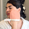 Folia Body Exfoliating Face Mitt - model shown using product on face