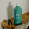 Kerzon Laundry Soap - Parc des Buttes Chaumont (1 L) - product shown on top of wooden counter.