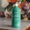 Kerzon Laundry Soap - Parc des Buttes Chaumont (1 L) - product shown in front of floral background. 