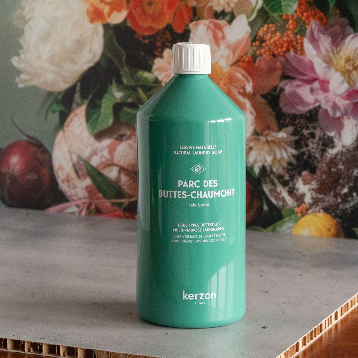 Kerzon Laundry Soap - Parc des Buttes Chaumont (1 L) - product shown in front of floral background. 