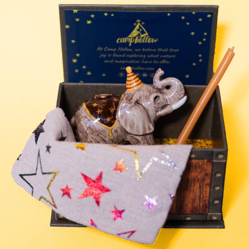 Camp Hollow Elephant Cake Topper - product shown with included candle and bag inside packaging