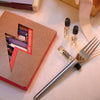 Maison Matine Discovery Set (11 x 2 ml) on a light surface, with three small vials shown, and a silver metal fork resting on the surface.
