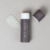 Orchid + Ash But, First Perfume Priming Balm - product shown with cap off next to product texture swatch