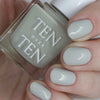 Tenoverten Nail Polish - Dover - model shown holding product and wearing color on nails