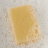 Poetica Lemon Myrtle & Cardamom Botanical Garment Bar Soap (3 oz) - Product shown in water with soap bubbles