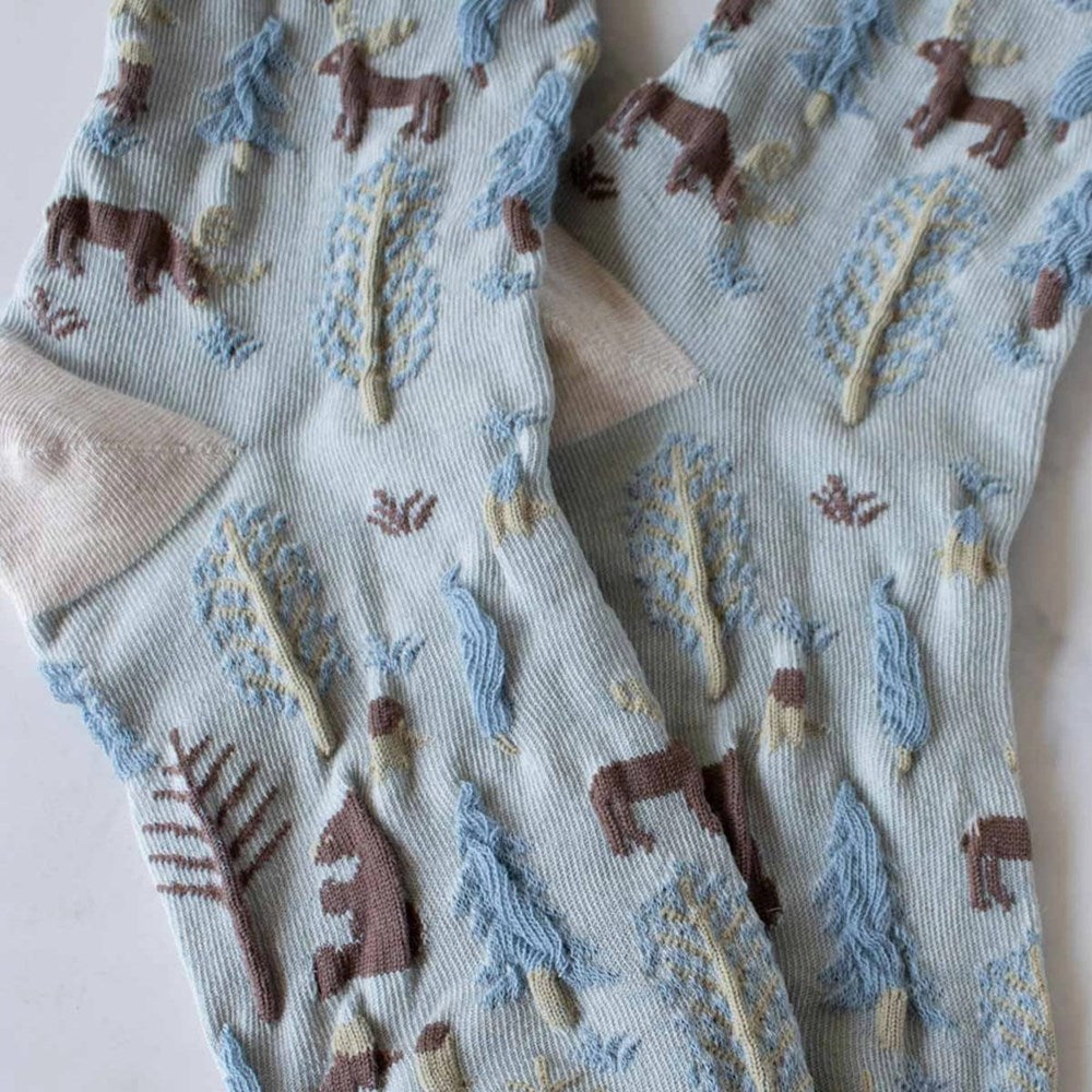 Close up of Tiepology Winter Forest Casual Socks - Oatmeal & Denim color with reindeer and trees.