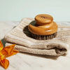 Lifestyle shot of Kate McLeod The Dry Brush on folded towel.