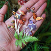 Model holding Moth & Myth Ferns & Friends Psychedelic Mini Set (7 pcs) in palm of hand