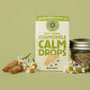 Lifestyle shot of Chamomile Life Easy Herbal Chamomile Calm Drops (85 g) with chamomile flowers and Calm Drops in the background