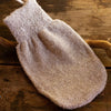 La Selva Positano Italian Hemp Exfoliating Glove - product shown on wooden table