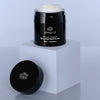 Odacite Retinol Therapy Renewing Hand Cream - product shown on white block next to lid