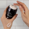 Odacite Retinol Therapy Renewing Hand Cream - model shown holding product with swatch on hand