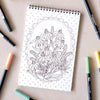 Antiquaria Wildflowers Premium Coloring Book - product interior shown next to pens