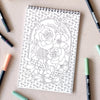 Antiquaria Wildflowers Premium Coloring Book - product interior shown next to pens