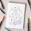 Antiquaria Wildflowers Premium Coloring Book - product interior shown next to pens