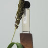 Hima Jomo Winter In Manaslu Eau de Parfum - product shown on wood next to plant