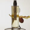 Hima Jomo Tchai Eau de Parfum - product shown in front of flower