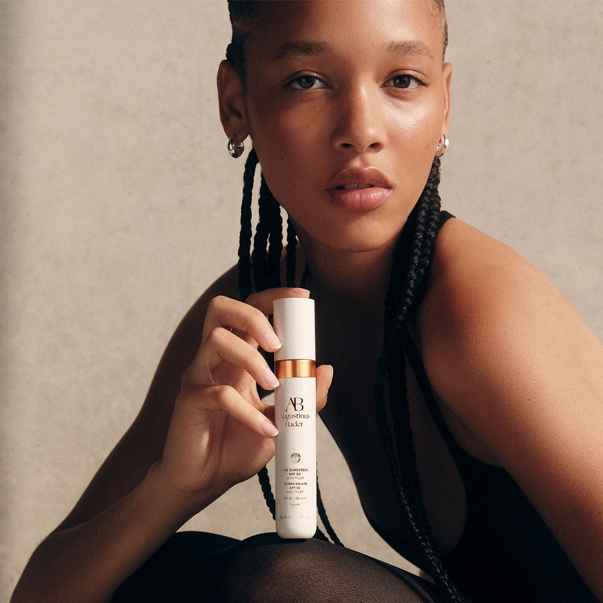 Augustinus Bader The Mineral Sunscreen SPF 50 (30 ml) - model shown holding product