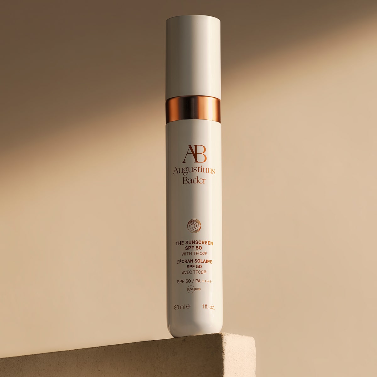 Augustinus Bader The Mineral Sunscreen SPF 50 (30 ml) - product shown on top of stone