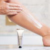 Olverum Body Polish - model shown applying product to leg