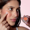 Odacite Color Balm SPF 50 - Golden Hour - model shown holding and using product