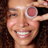 Odacite Color Balm SPF 50 - Sienna Rose - model shown holding product