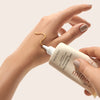 Minori Daily Mineral Face Sunscreen - Spf 30 - model shown squeezing product on to hand