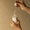 HYEJA Heartleaf Niacinamide Calming Serum - model shown dispensing product with dropper on arm