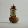 HYEJA Ginseng HPR Retinoid + Bakuchiol Face Oil - product shown on top of rock