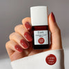 Kure Bazaar Le Vernis Serum Sunset - L'Orange 01 (10 ml) - model shown holding product