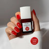 Kure Bazaar Le Vernis Serum Sunset - Le Rouge 01 (10 ml) - model shown holding product