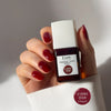 Kure Bazaar Le Vernis Serum Sunset - Le Rouge 02 (10 ml) - model shown holding product
