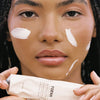 FORAH Unscented Everyday Mineral Sunscreen SPF 25 - model shown holding product with product swatches on face