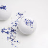 Bathorium Snooze Bath Bomb - two product shown next to flower petals
