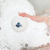 Bathorium Snooze Bath Bomb - model shown holding product in water