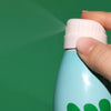 Bask Sunscreen Non-Aerosol Mineral Sunscreen Continuous Spray SPF 30 - close up of model spraying product