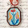 Maris Mirum Small Locket - Love Birds - product shown on decorative paper