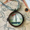 Maris Mirum Small Locket - Sail No. 8 - product shown on top of antique map