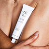 Baby le Bebe Sun Glaze Body Balm - model shown holding product