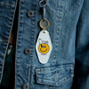 Three Potato Four 3P4 X Peanuts Key Tag - Snoopy Smiley - product shown attached to models jacket